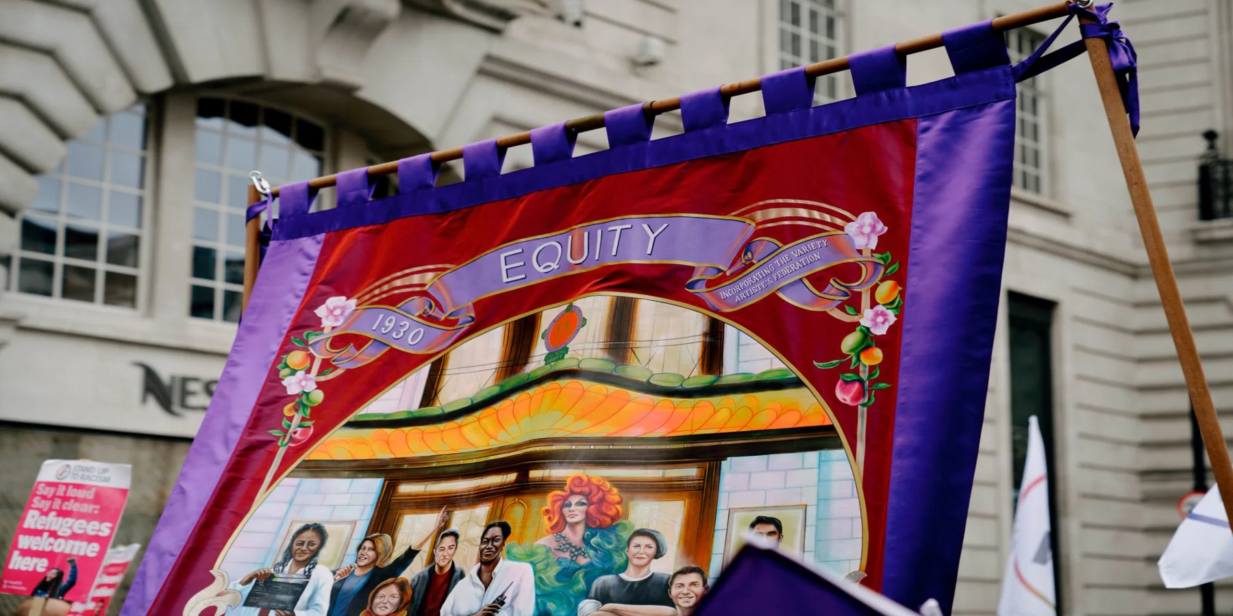 Painted purple and red Equity Banner with the date 1930, showing a variety of different performers.